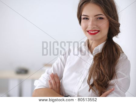 Attractive businesswoman with her arms crossed stnding