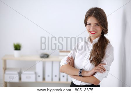 Attractive businesswoman with her arms crossed stnding