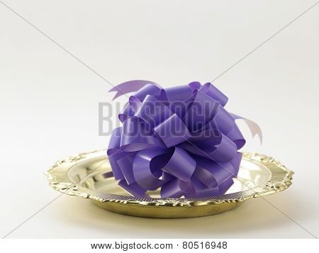 opening ceremony concept- purple ribbon bow on the golden plate