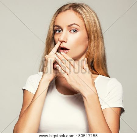Woman picks his nose finger. Female climbs a finger in nose. Embarrassment