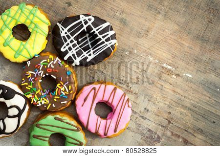 Bright Donuts On Wooden Background