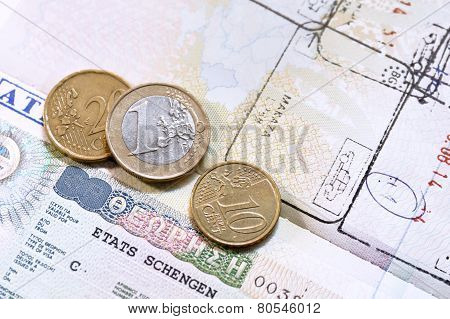 Euro coins on passport with greek European Union visa