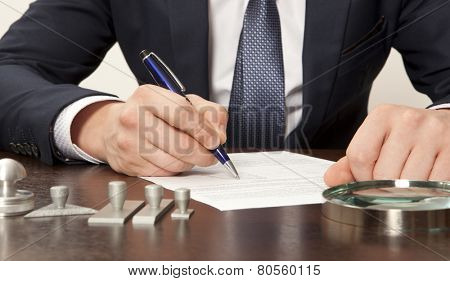 Lawyer, notary signs the documents from our office