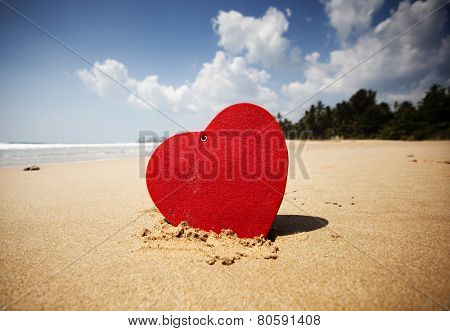 Red heart on exotic sandy beach - Valentine's day concept