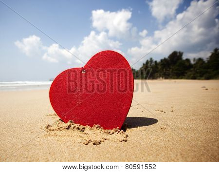 Red heart on exotic sandy beach - Valentine's day concept