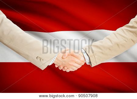 Businessmen Handshake With Flag On Background - Austria
