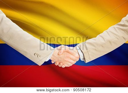 Businessmen Handshake With Flag On Background - Colombia