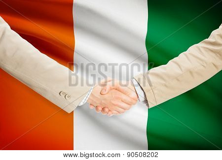 Businessmen Handshake With Flag On Background - Ivory Coast