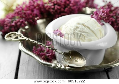 Beautiful composition with tasty ice cream and lilac flowers