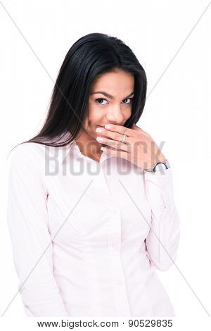 Businesswoman covering her mouth with hand isolated on a white background. Looking at camera