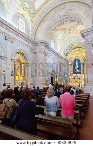 Terras de Bouro, Portugal. April 06, 2015: Faithful praying in the interior of the Sanctuary of Sao Bento da Porta Aberta. Pope Francis promoted it to Basilica in the 400th anniversary in March, 21st