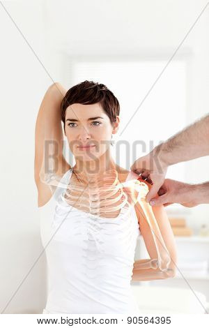 Digital composite of Highlighted bones of woman at physiotherapist