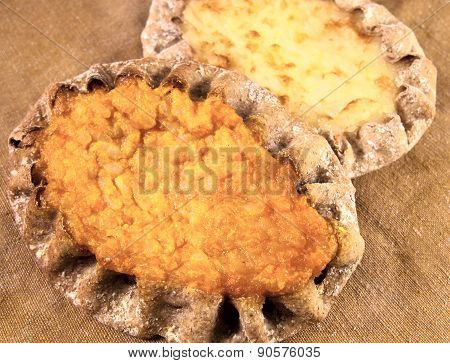 Two Karelian pies with carrot and rice filling