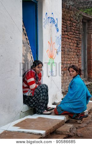 Indian Young Women Sit And Chat On A House Porch