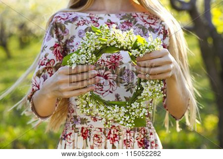 Young Woman Holding Wreath From Lily Of The Valley