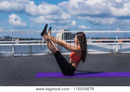 Yoga And Meditation In A Modern Urbanistic City. Young Attractive Girl - Yoga Meditates Against Mode