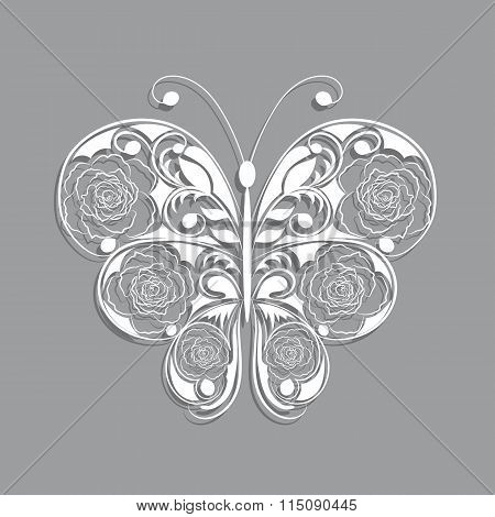 White paper butterfly with floral pattern on gray background.