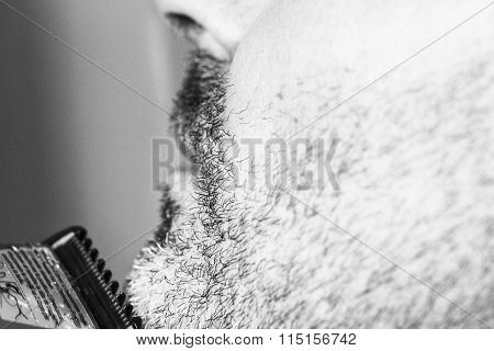 Hairdresser cutting beard, black and white picture