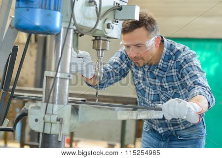man using a metal driller