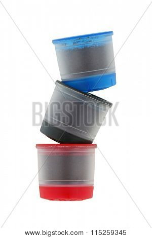 Different types of single serve Coffee capsules in blue, black and red isolated on white background