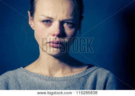 Young woman suffering from severe depression/anxiety/sadness, crying, tears coming from her eyes