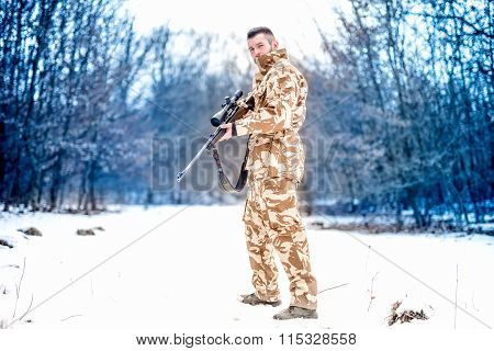 Army Sniper During Military Operation Using A Professional Rifle On A Cold Winter Day