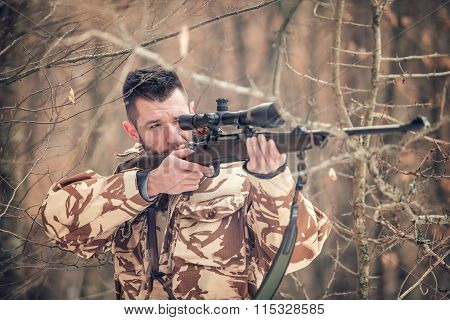 Man Holding A Sniper And Shooting On An Open Season, Looking Through Scope