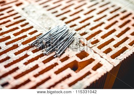 Nails And Tools On Construction Site, Bricks Layer And Mortar. New Building Site