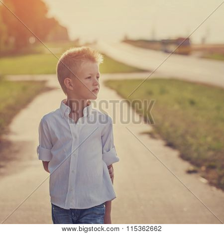 Portrait Of Achild On The Road In The Sunny Day