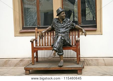 Prague, Czech Republic - April 16, 2010: Sculptural Composition With A Man Sitting On The Bench At T