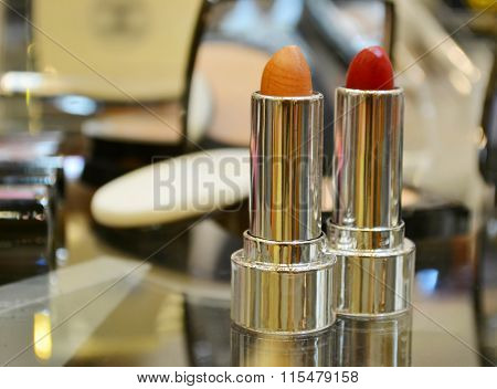 Set of colorful lipsticks with other cosmetics on a dressing table