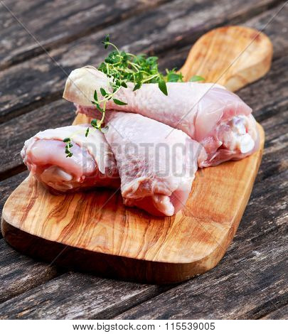 Raw Chicken Drumsticks with thymi