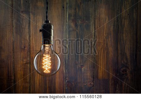 Vintage Incandescent Edison Type Bulb On Wooden Background