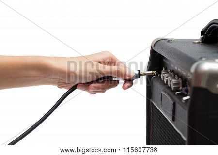 Woman Hand Plugging Into The Amplifier Guitar On White Background