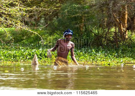 KENYA Nairobi January 3, 2013: A fisherman pulls out fish from the nets Jan. 3, 2013 in Nairobi  Ken