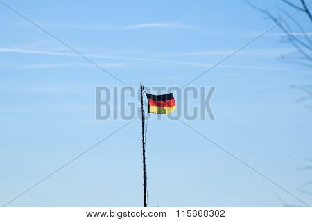 German flag in front of blue sky