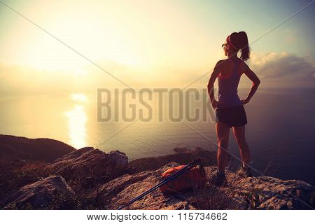 one young woman backpacker hiking on sunrise seaside mountainpeak