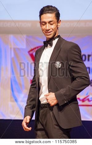 Male Physique Model Shows His Best In Suit On Stage