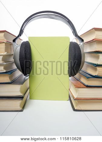 Audio book Stack of hardback books and electronic reader. Electronic library concept. Back to school