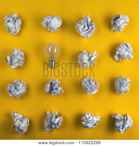 Crumpled paper balls and blank sheet of paper with pencil on yellow background. Paper wad. Creativit