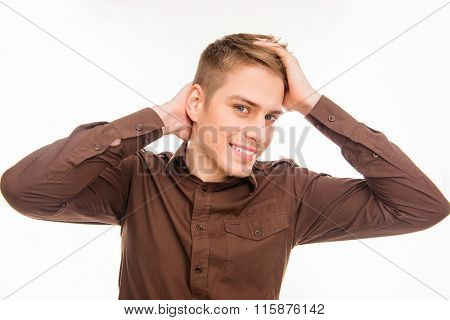 Attractive  Young Smiling Man In Brown Shirt Touhing His Hair