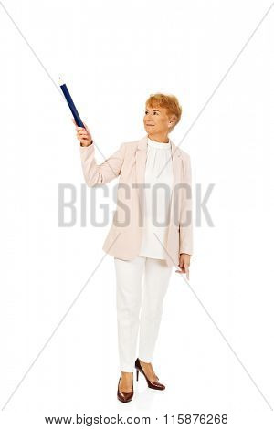 Smile elderly woman pointing up with hege pen
