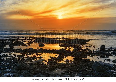 Deep Orange Reflections At Rocky Beal Beach