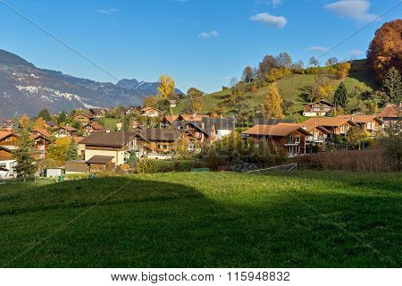 Green meadows and typical Switzerland village near town of interlaken, canton of Bern, Switzerland