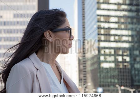 Young latin professional woman with glasses in the city. Photographed in NYC in November 2015