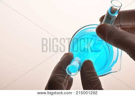 Hands Of Laboratory Worker With Test Tubes And Beaker