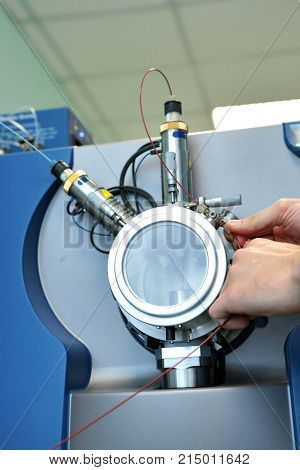 Adjust The Mass Spectrometer. The Man Analyzes The Device For Determining The Masses Of Atoms. Devic