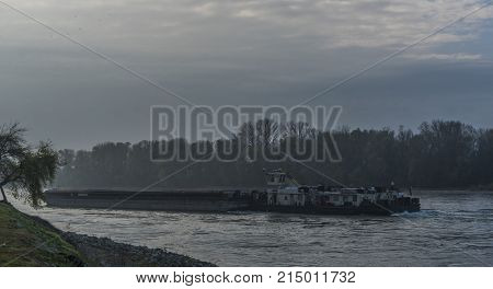 Big cargo boat in Devin village on Dunaj river in autumn morning