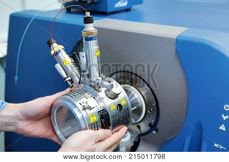 Adjust The Mass Spectrometer. The Man Analyzes The Device For Determining The Masses Of Atoms. Devic