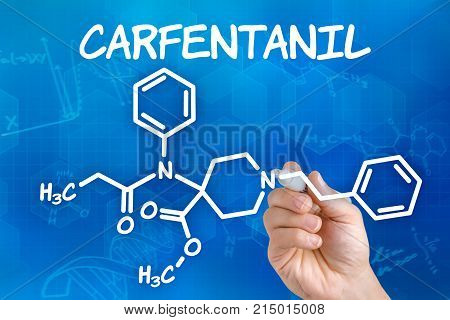 Hand With Pen Drawing The Chemical Formula Of Carfentanil